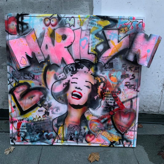 Beautiful artwork portraying Marilyn Monroe with 3D letters above her with the text MARILYN. She is painted and sprayed through the use of stancil street art.